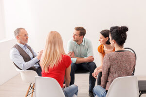 Listening to a counselor in group session at benzo detox center in Florida