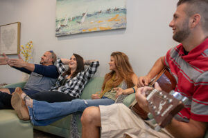 man playing guitar during gathering