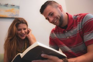 man and woman reading book