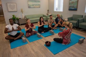 instructor leading yoga therapy session