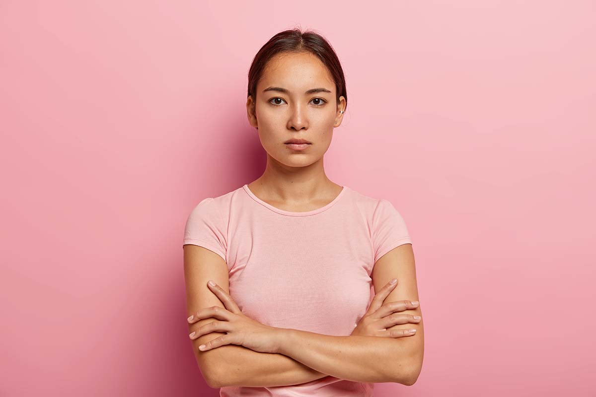 opioid vs opiate woman wearing pink against pink wall opioid vs opiate