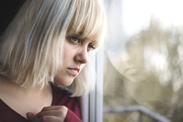 Drug misuse young girl staring out window dealing with drug misuse in parents