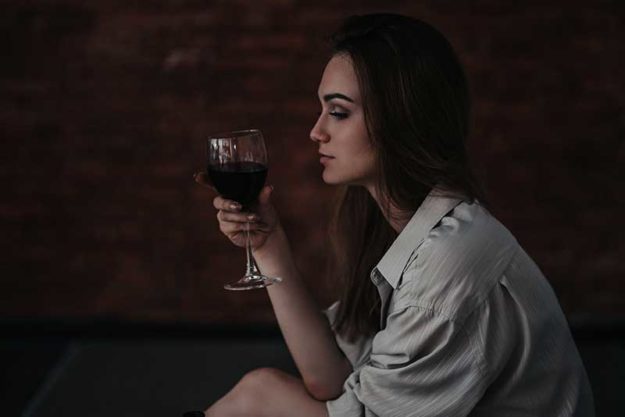 What Are the Dangers of Drinking Alcohol_ Woman pondering the dangers of drinking alcohol