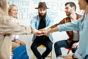 detox center clients putting their hands in the middle