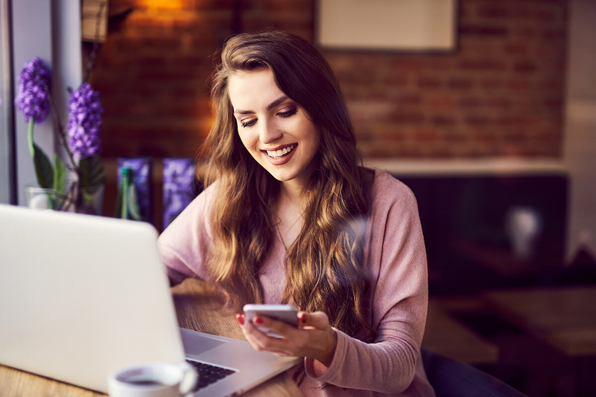 how to choose a detox center young woman using phone and laptop to learn how to choose a detox center