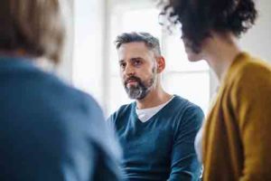 patient in group therapy listening in medical detox center