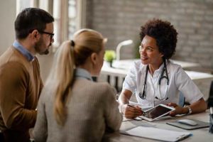 couple learning about drug detox from doctor