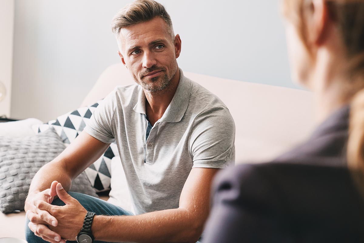 Alcohol Withdrawal Symptoms- Understanding the Process of Detox A man listening to a list of alcohol withdrawal symptoms