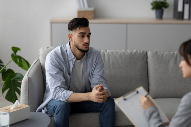 Man sitting on couch in counseling session